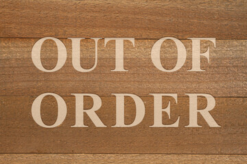 Out of Order sign on weathered wood