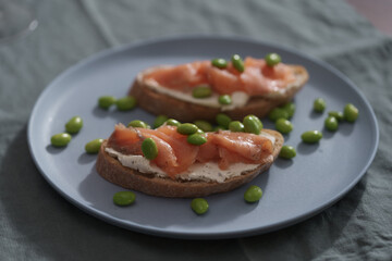 Bruschettas with cream cheese and salmon on dining table