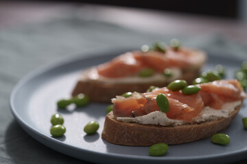 Bruschettas with cream cheese and salmon on dining table