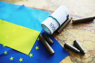 The concept of European Union support for Ukraine in a military conflict. Solidarity. Politics. Flags are on the table.