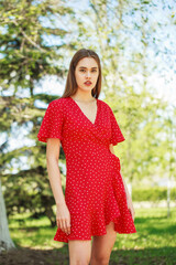 Fototapeta premium Young beautiful brunette girl in summer dress