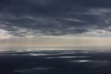 Beams of sunlight pierce low clouds over the Pacific Ocean in northern Oregon. This Pacific Northwest is known for its spectacular outdoor scenery.