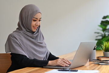 Young Arabian businesswoman or student using laptop for working or online learning, Remote work  or...