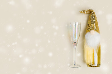 Champagne bottle decorated hat of dwarf with golden sequins, wine glass. Christmas and New Year...