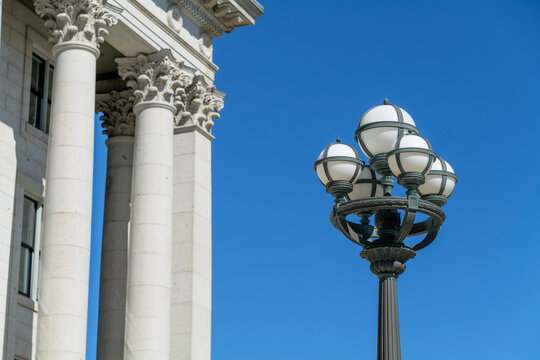 Part of the Capitol building with columns and street lamp on blue sky background with copy space. High-quality photo