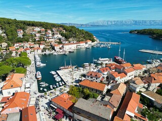 Naklejka na ściany i meble Boats moored in harbour Jelsa Croatia town on Hvar drone aerial view