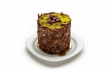 Isolated shot of a plate of chocolate cake with nut toppings on a white background