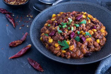 Close up of a bowl of homemade black bean and corn chili, ready for eating.