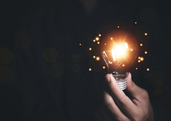businessman holding a light bulb Digital technology. imagine an idea Creative and innovative.	
