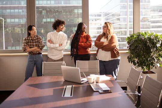 A group of  young colleagues are talking during a break in the office