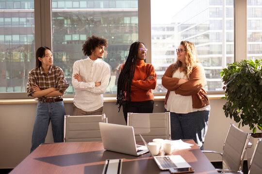 A group of young colleagues in the office are taking a break together