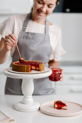 Confectioner decorates cherry cake for the holiday. High quality photo