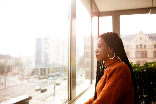 African, young girl in the office in front of the window 