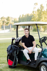 Young man in golf car outdoors. High quality photo