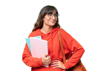 Young student caucasian woman over isolated background posing with arms at hip and smiling