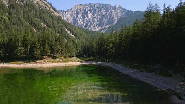 Gruner See, Austria aerial drone fly above lake. Peaceful mountain view with famous green lake in Styria. Turquoise green color of water. Travel destination