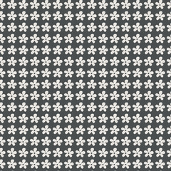 Medium scale grid repeat of an off-white simple silhouette flower repeat on a dark grey background