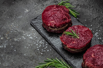 Beef Tenderloin fillet with rosemary and spices. Preparing fresh beef steak ready to cook, Long banner format. Restaurant menu, dieting, cookbook recipe. place for text. top view