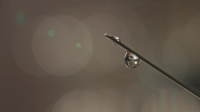 Close up shot of Syringe with droplet.