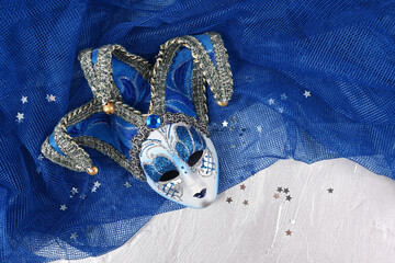 Venetian mask on a blue and silver background