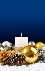 Christmas candle on a dark blue background side view vertical