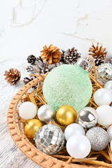 Christmas composition in a wicker plate with straw сlose up