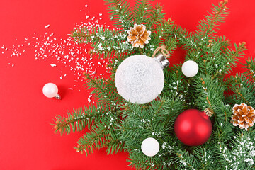 Christmas tree toys on a branch and a red background horizontal