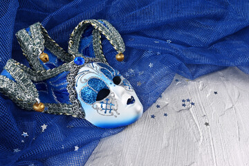 Venetian mask on a blue and silver background