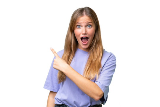 Young beautiful woman over isolated background surprised and pointing side