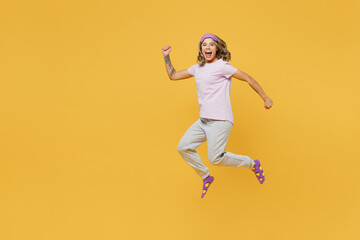 Fototapeta na wymiar Full body young happy excited fun woman she wear purple pyjamas jam sleep eye mask rest relax at home jump high run fast hurrying isolated on plain yellow background studio portrait Night nap concept