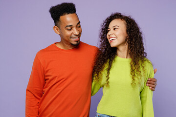 Obraz premium Young smiling happy fun cheerful couple two friends family man woman of African American ethnicity wear casual clothes together hug look to each other isolated on pastel plain light purple background.