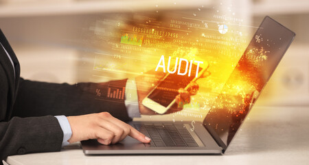 Closeup of businessman hands working on laptop
