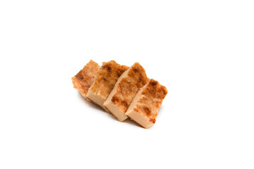 La Quesada Pasiega is a typical dessert from the Valles Pasiegos region, in Cantabria (Spain) made with curdled milk, eggs, flour, lemon peel and butter. Isolated on white background.