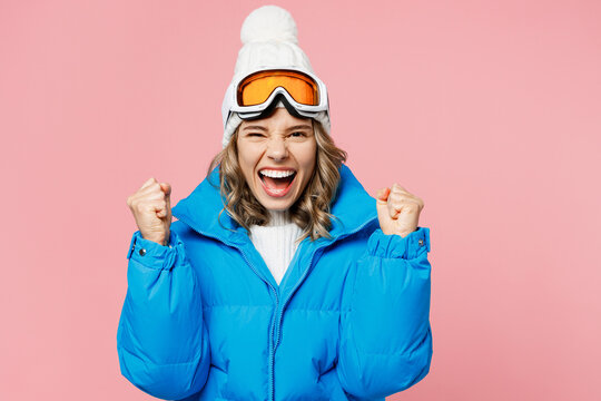 Snowboarder Happy Woman Wear Blue Suit Goggles Mask Hat Ski Padded Jacket Do Winner Gesture Celebrate Isolated On Plain Pastel Pink Background. Winter Extreme Sport Hobby Weekend Trip Relax Concept