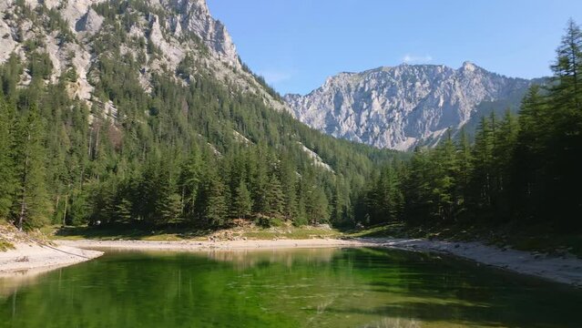 Gruner See, Austria aerial drone fly above lake. Peaceful mountain view with famous green lake in Styria. Turquoise green color of water. Travel destination