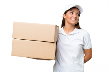 Delivery caucasian woman holding boxes isolated on green chroma background thinking an idea while looking up