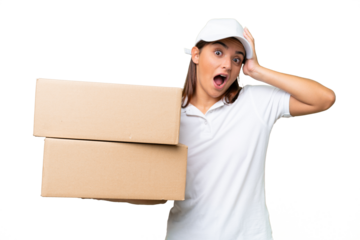 Delivery caucasian woman holding boxes isolated on green chroma background with surprise expression
