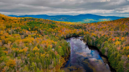 Autumn forest on the riverside, marvel at the amazing views of the autumn river. Campton, New...