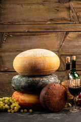 Cheese wheel and wine on a wooden background. farmer market. place for text