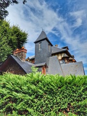 A typical building in the northern region of France. A building with a tiled roof in Etretat.