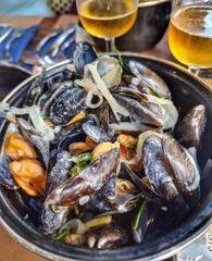 Stewed mussels in cream sauce. A typical lunch in the Normandy region of France. Food in Etretat.