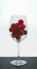 wine glass filled with grape cluster