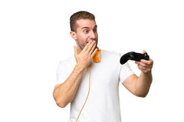 Young handsome man playing with a video game controller isolated on green chroma background with...
