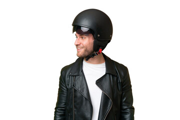 Young caucasian man with a motorcycle helmet isolated on green chroma background looking side