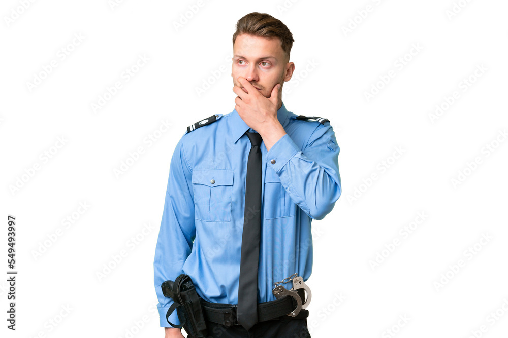 Wall mural Young police man over isolated background having doubts and with confuse face expression