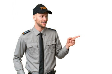 Young security caucasian man over isolated background pointing finger to the side and presenting a product