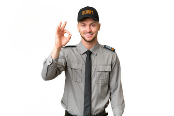 Young security caucasian man over isolated background showing ok sign with fingers