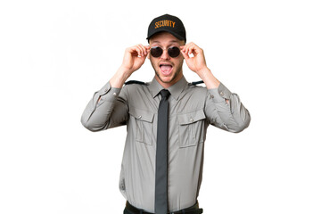 Young security caucasian man over isolated background with glasses and surprised