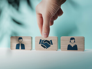 Wooden blocks with an icon of a woman and a man and mediation. Concept of mediation between...