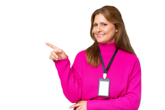 Middle-aged caucasian woman with ID card over isolated background pointing finger to the side